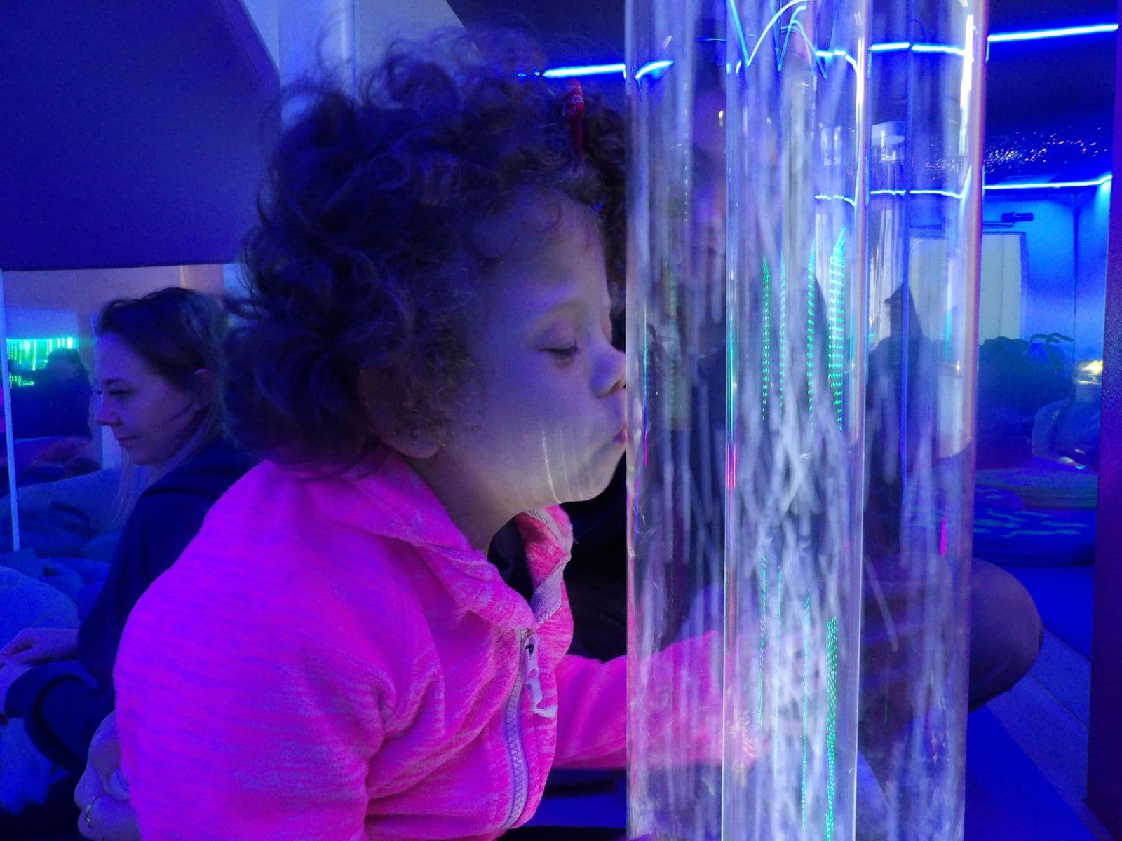Exploring the bubble tube in the sensory room